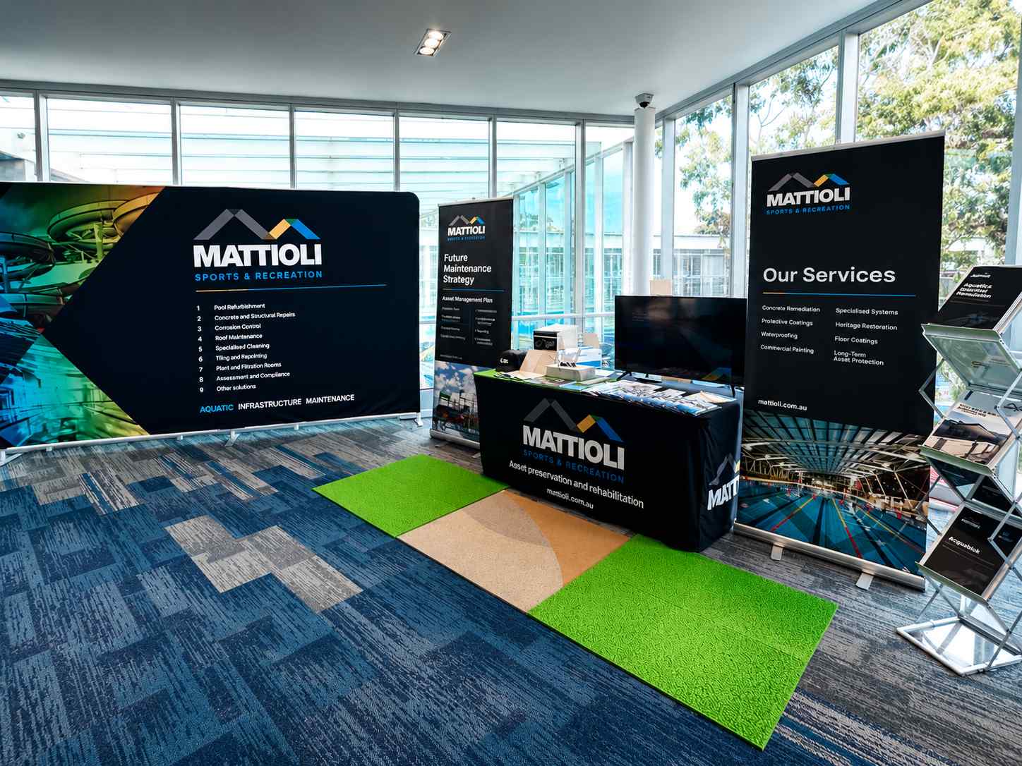 Branded event with stage, signage and audience inside a converted venue.
