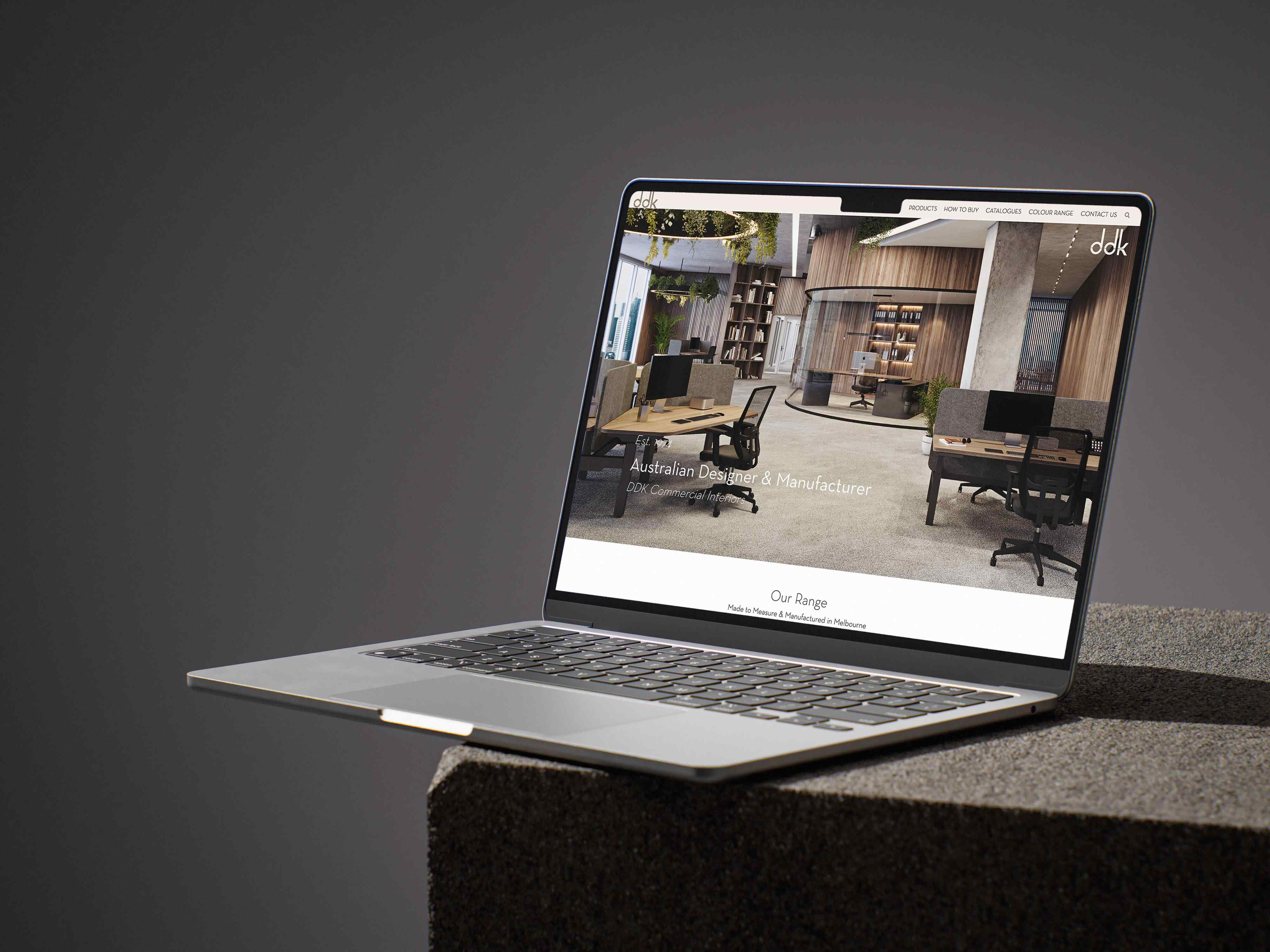 A laptop showing a modern marketplace interface, hands typing.